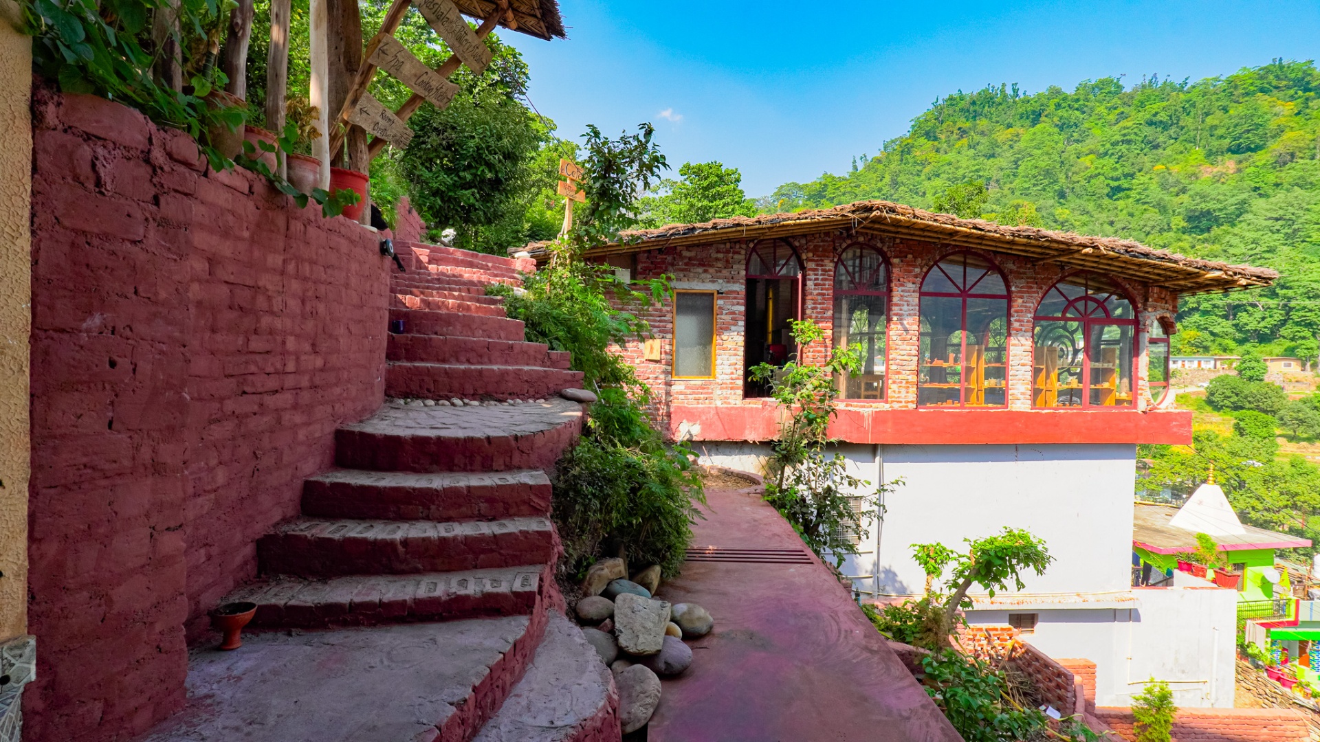 Hand-built brick and mud studios on the Aavya hillside