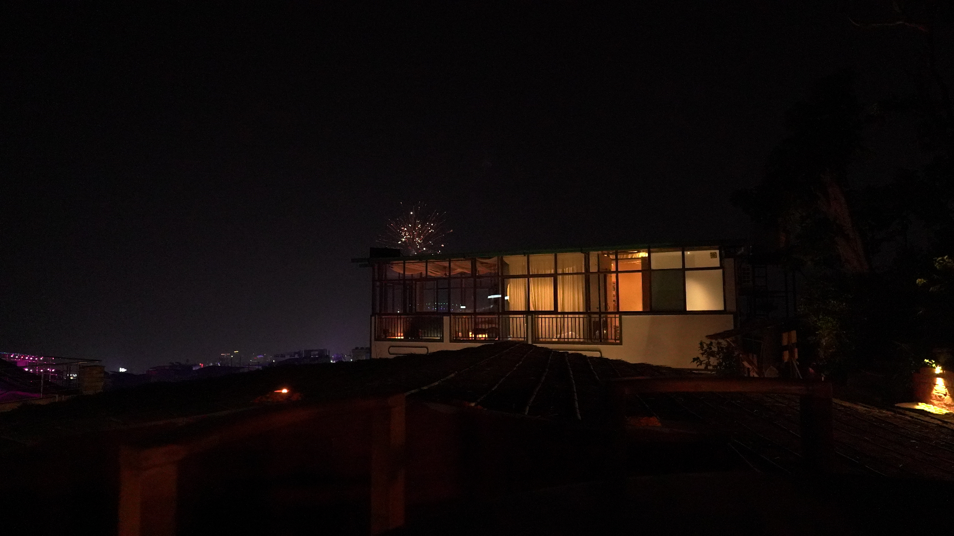 Aavya's pottery studio glowing on the hillside at night