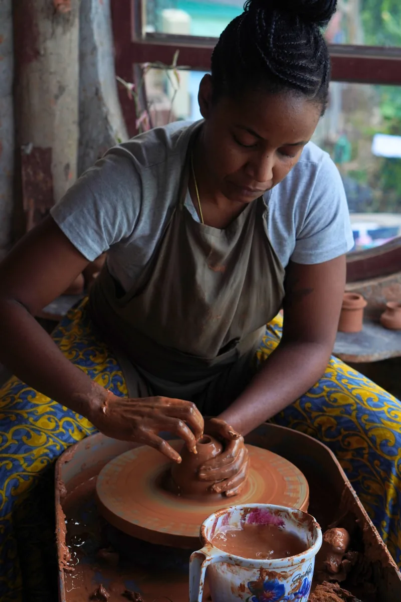A guest shaping a clay pot on the pottery wheel at Aavya Pottery & Art Studio