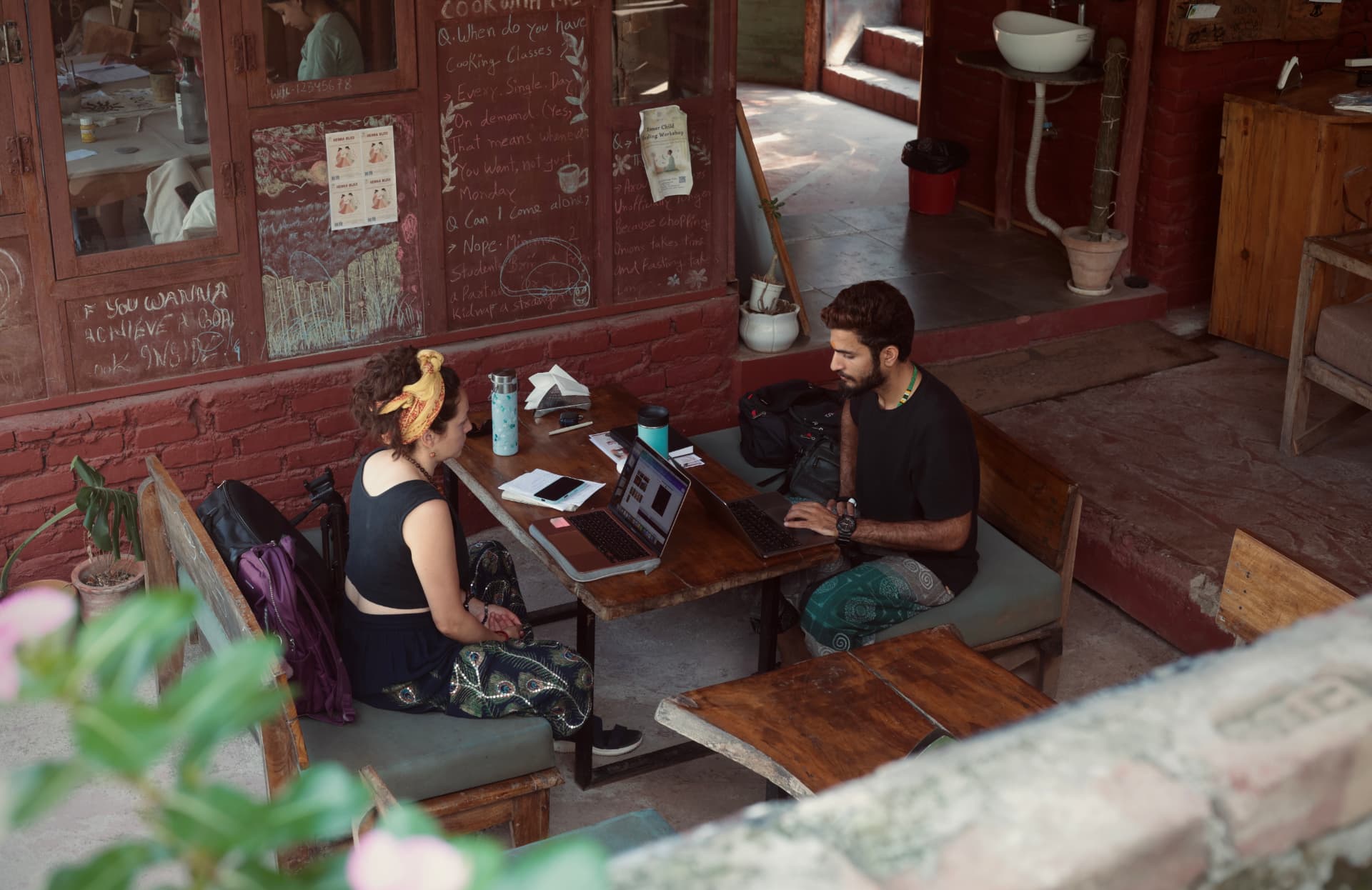 Guests working and relaxing at Aavya Café after a Tapas session