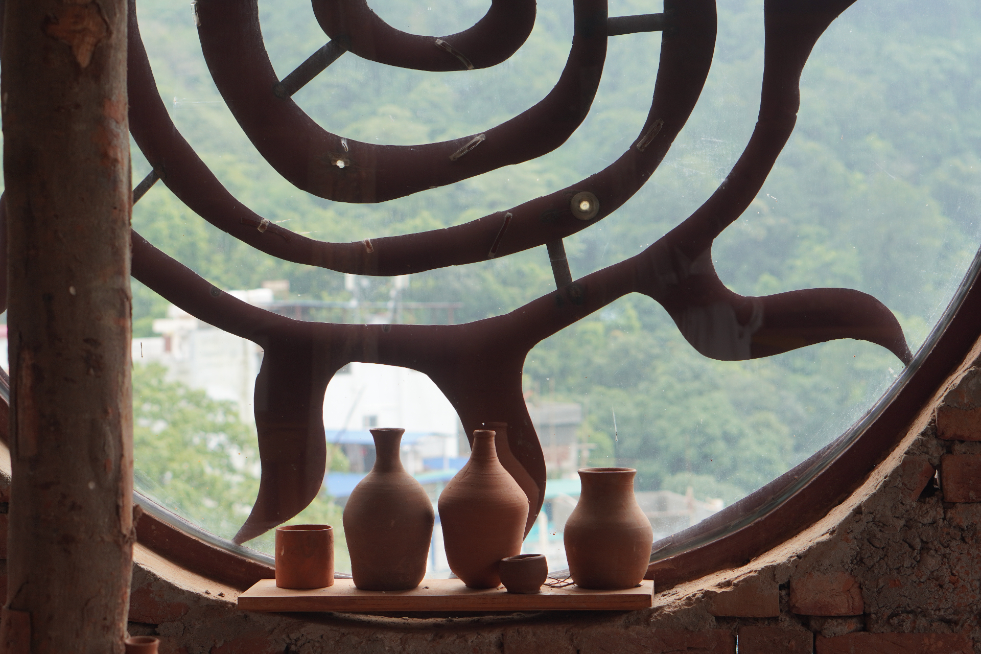 Hands shaping clay on the pottery wheel at Aavya studio