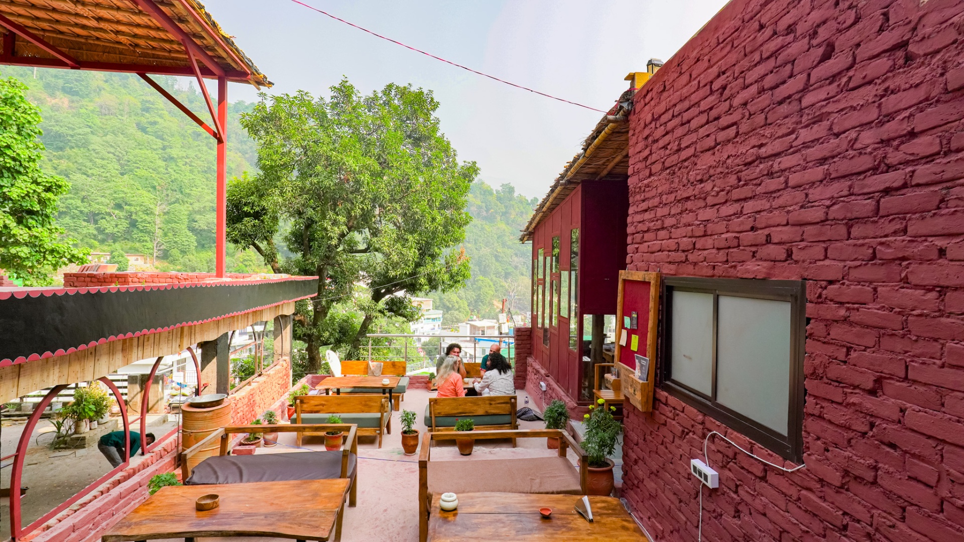 Café terrace at Aavya with a mountain view